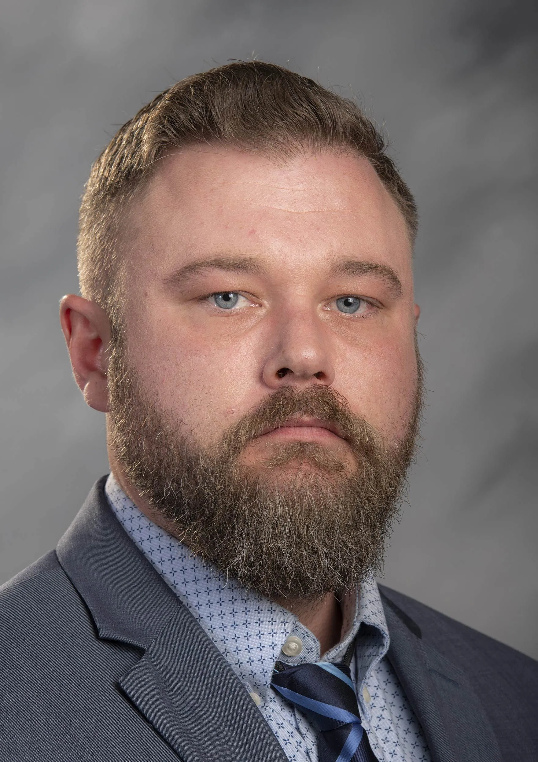 Kris Parsons headshot in suit and tie